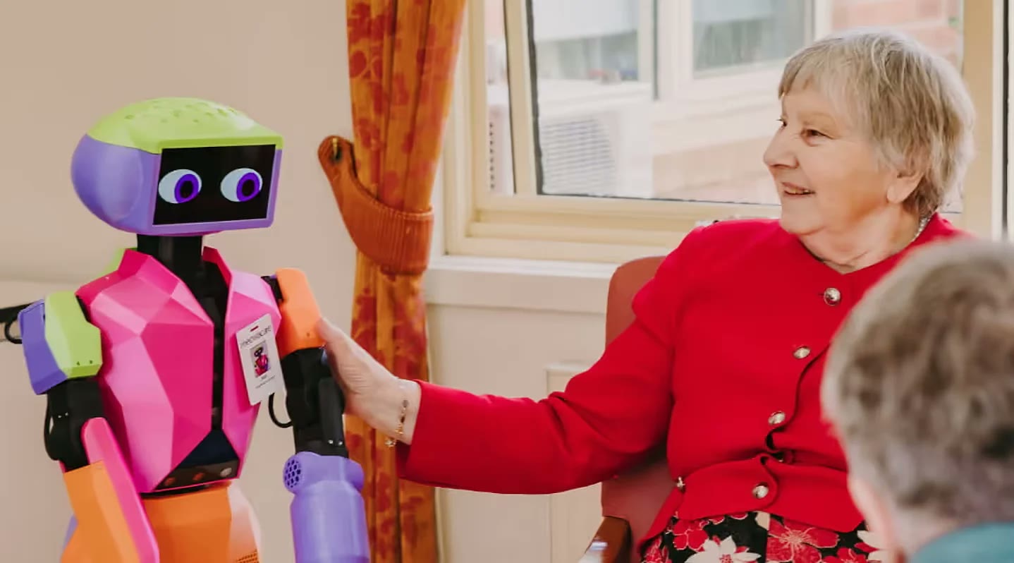 Abi, Andromeda's companion robot, with a resident in aged care